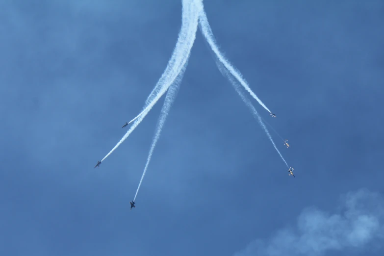three jets flying in opposite directions in the sky