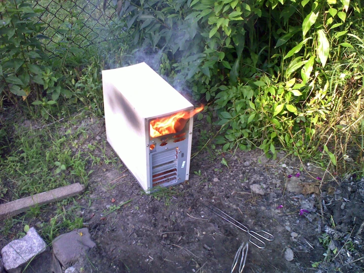 a small stove sitting on top of a cement ground