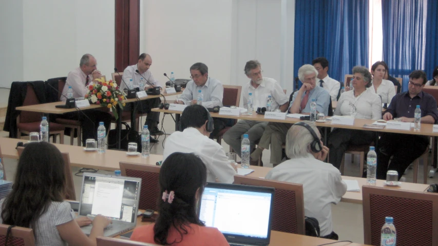 a group of people sitting in front of laptops and on their laps