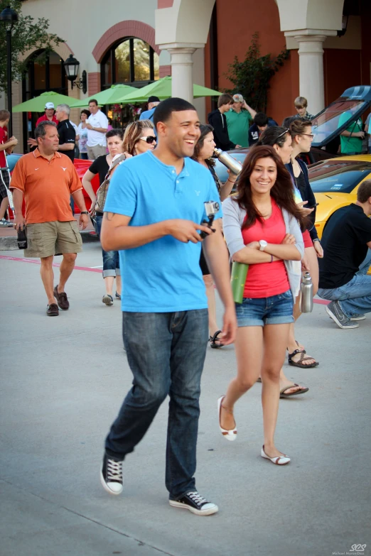 a man walks with another woman through the street