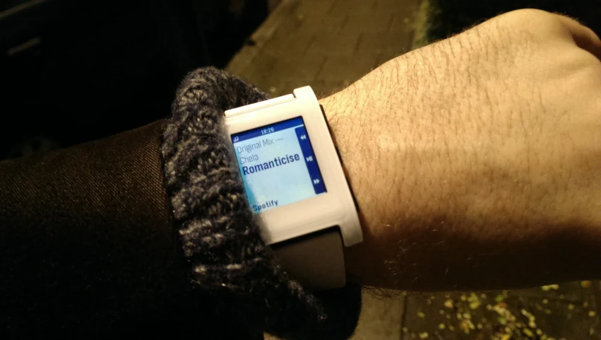 a man wearing a smart watch with an id attached to his wrist
