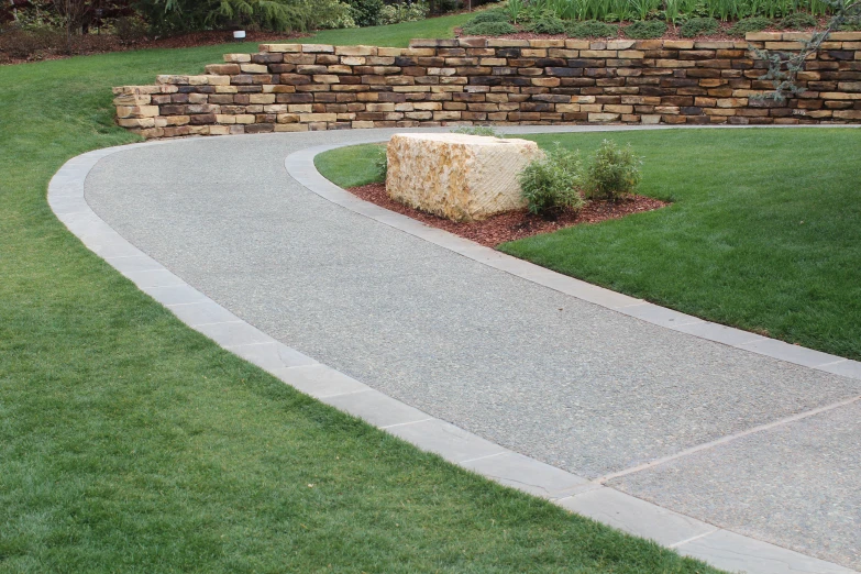 a road runs along the sides of grass and rocks