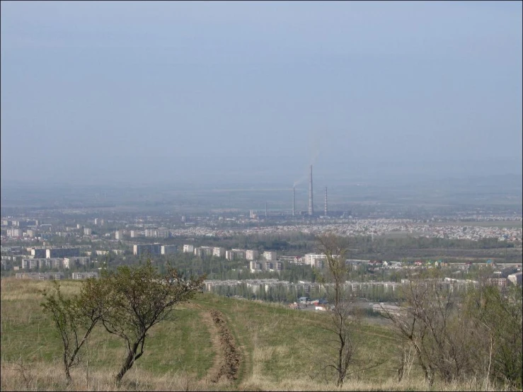 the distant city sits above the vast field