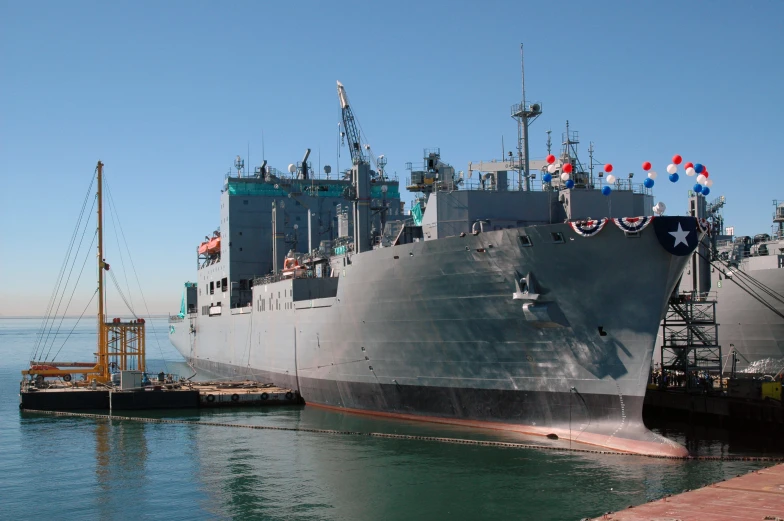 a large battleship parked at the dock