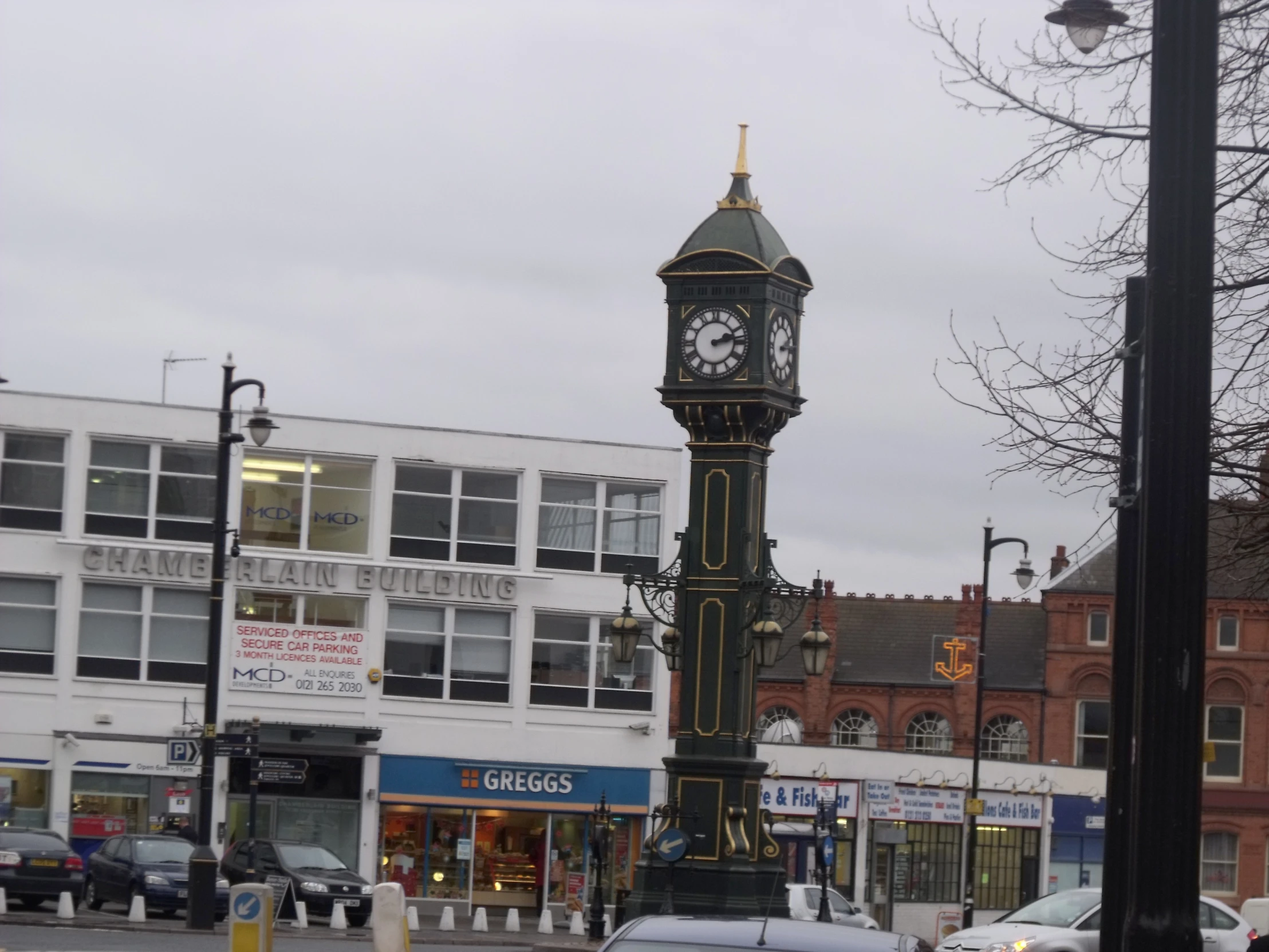 an ornate clock tower on the side of a busy street