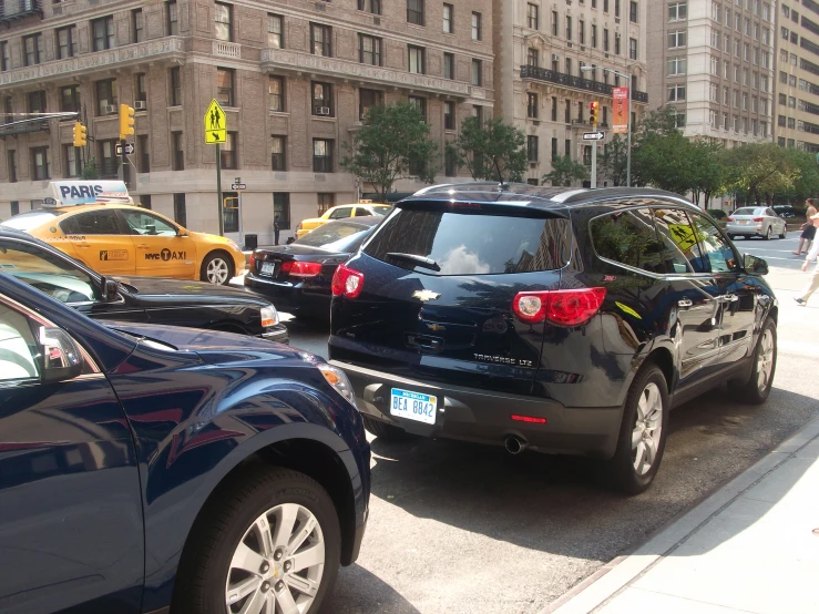 some cars that are sitting in the street