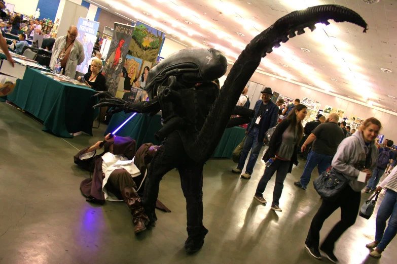 a group of people standing around a man in a star wars costume