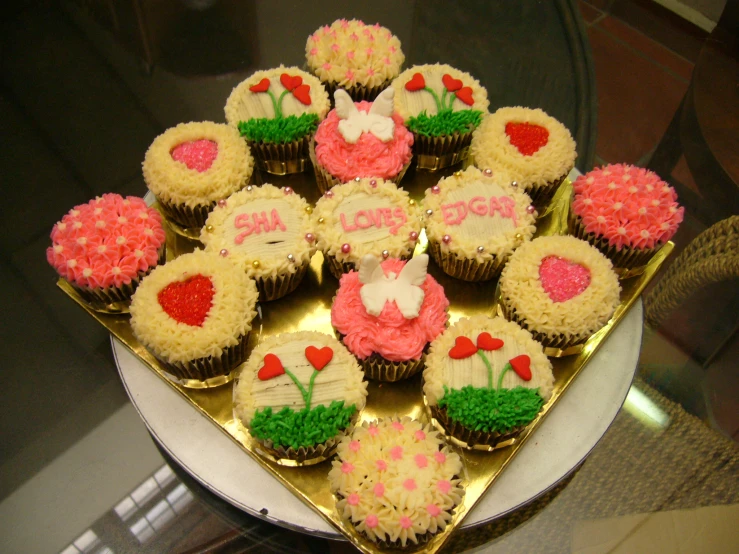 a tray of twelve valentine cupcakes are arranged in order to be filled with flowers