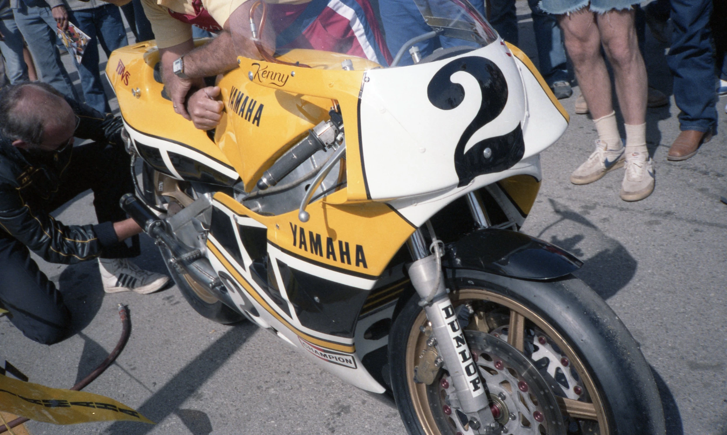 a yellow motorcycle with a number on it