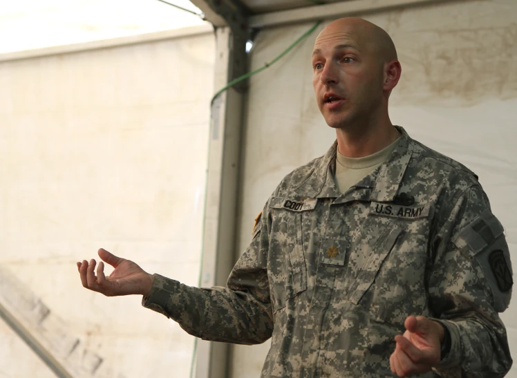 a man in uniform speaking while talking into microphone