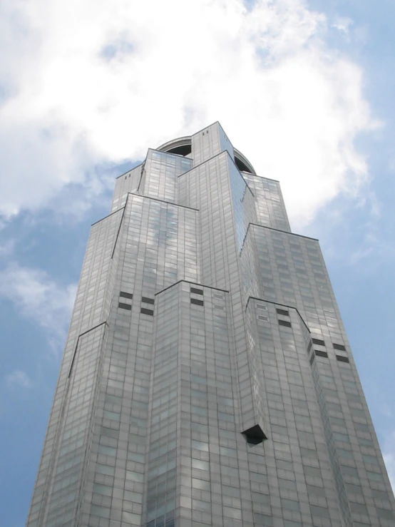 the top of an office building with a large black clock on the side of it