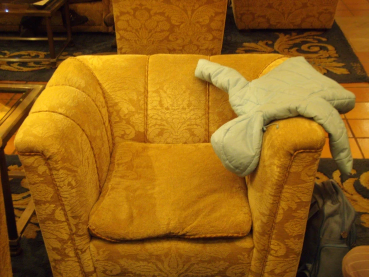 a yellow chair with a blue cushion sitting in it