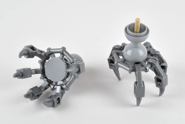 two silver robot legs are next to a light bulb