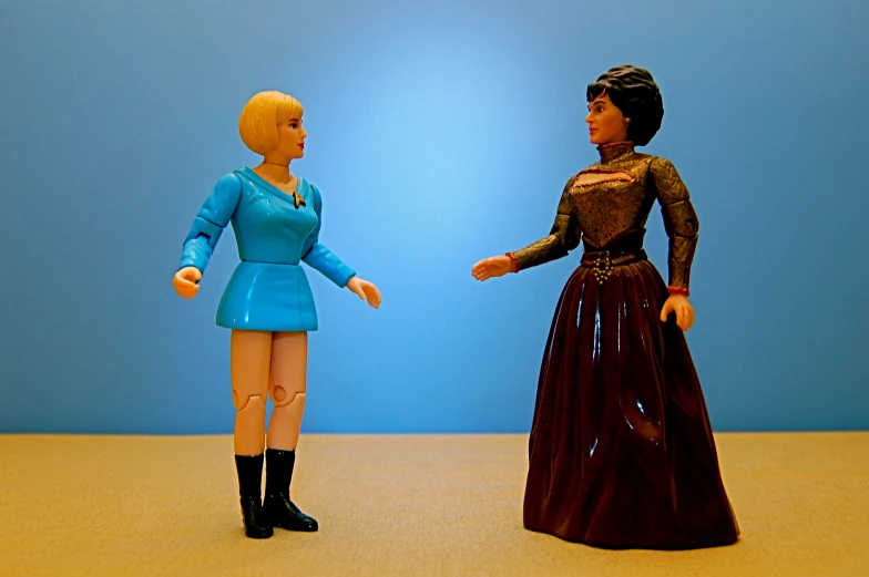 a pair of action figures in blue dresses