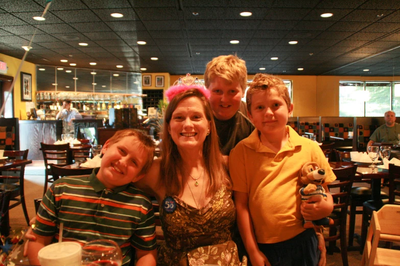 a woman, a man and three children in a dining room