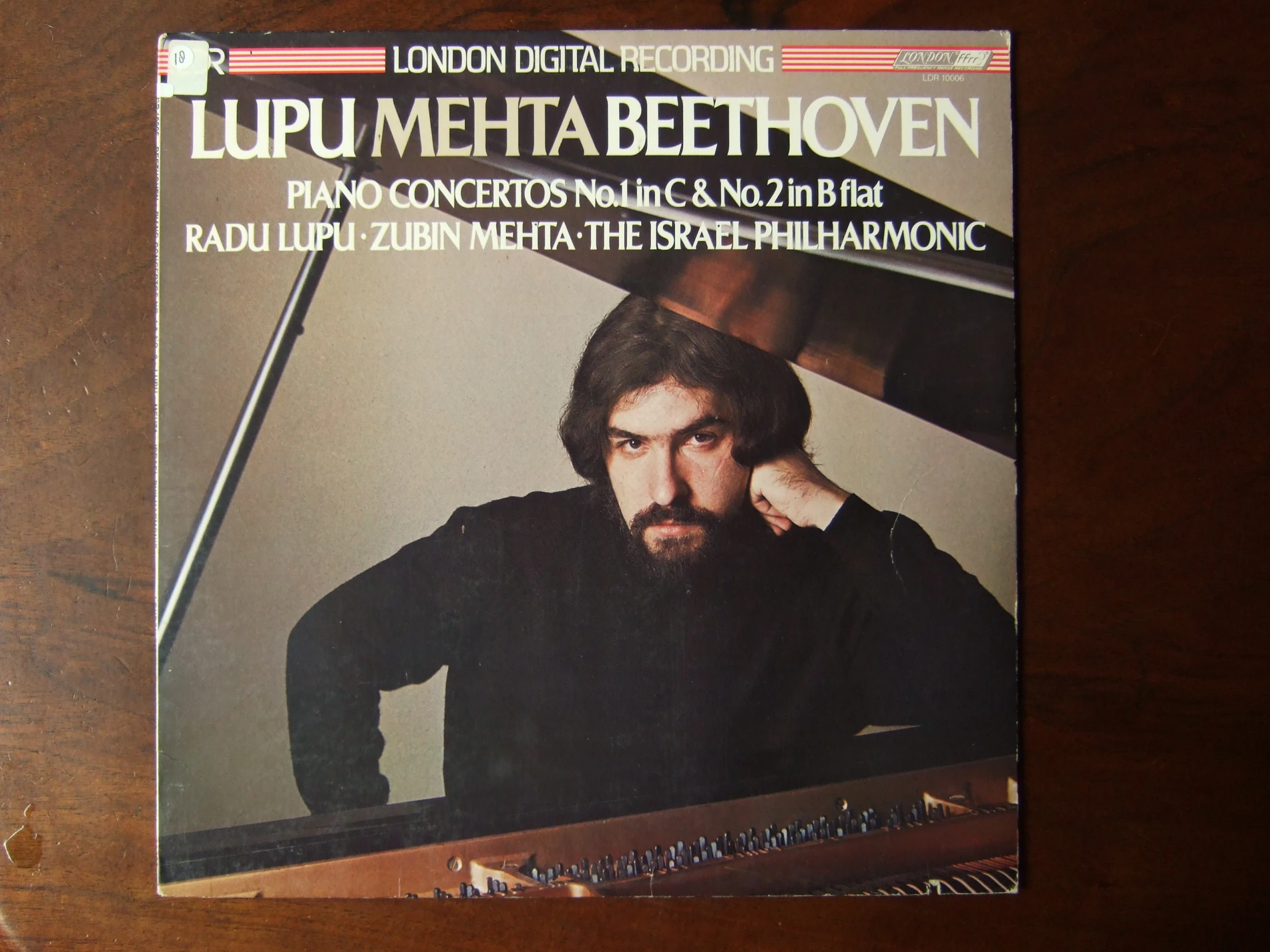 the front cover of a lp with an image of a man playing a piano