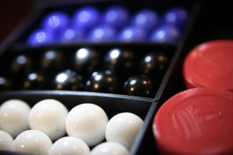 there are some bowling balls inside of some black trays