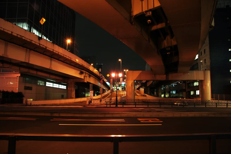 the road near the building is dark and empty