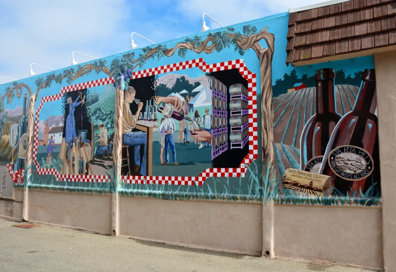 a wall mural with bottles, images and wine barrels