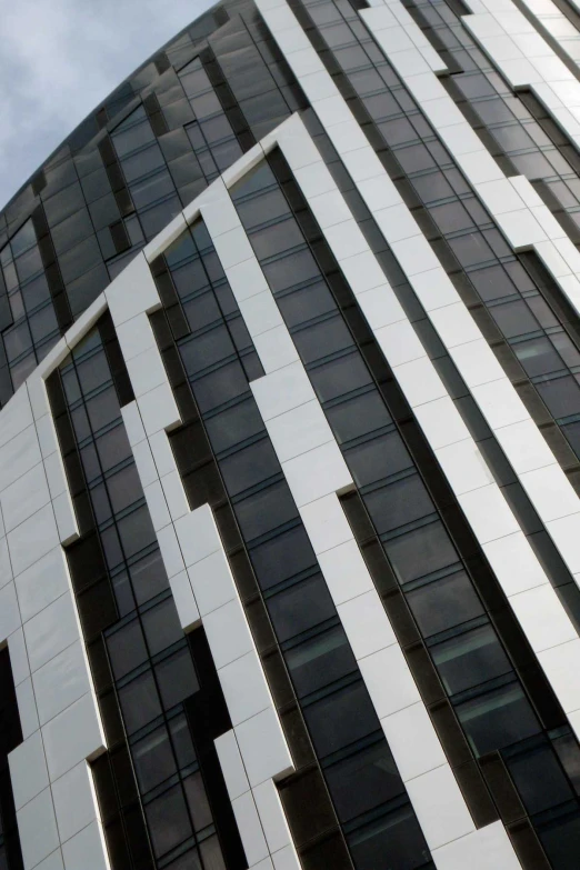 a tall building with lots of windows and a clock in front