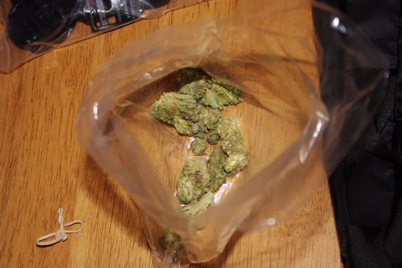 some marijuana is sitting in a bag next to scissors