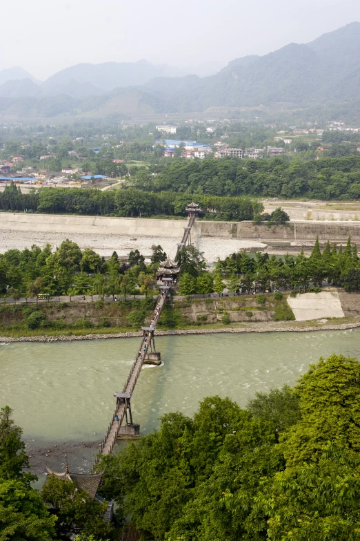 a train crossing a small bridge over a river