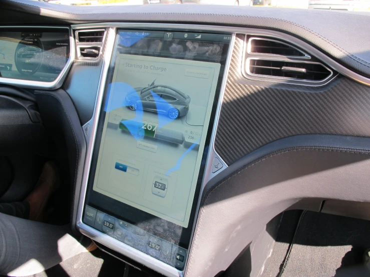 a smart phone sitting on the steering wheel of a car