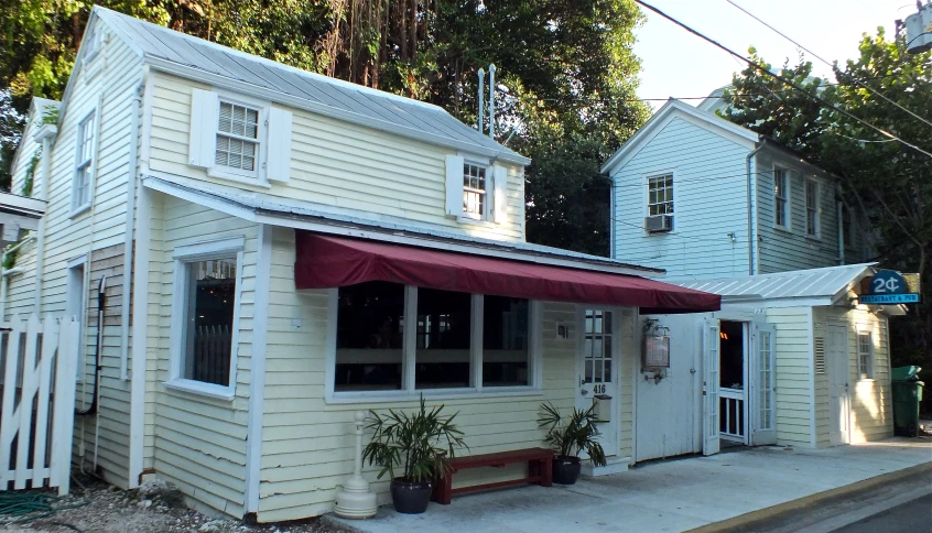 an outside corner of a building with a red awning on it