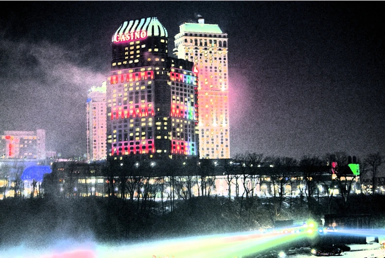 a large skyscr with lights and a bridge with water in it