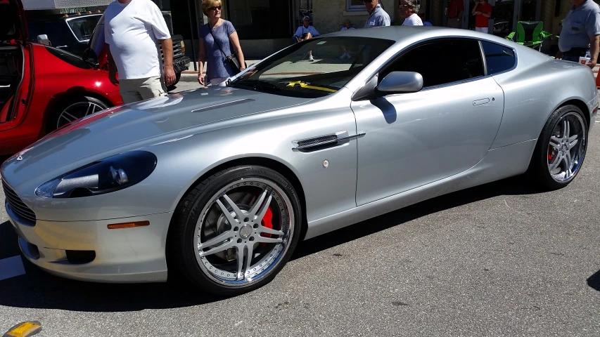 a silver sports car in front of other cars