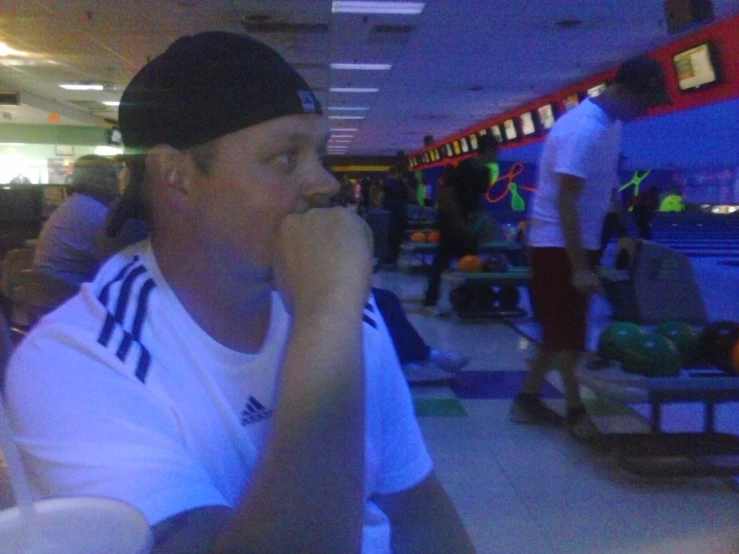 a man in the bowling alley is eating soing