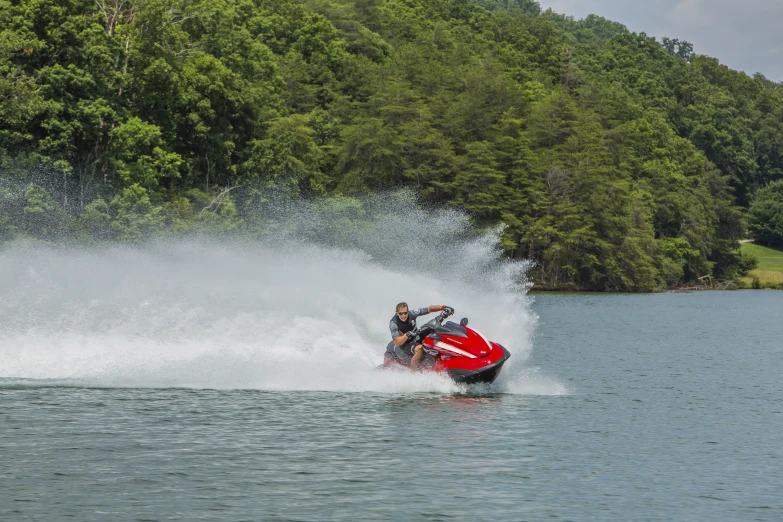 a person on a red jet ski in the water