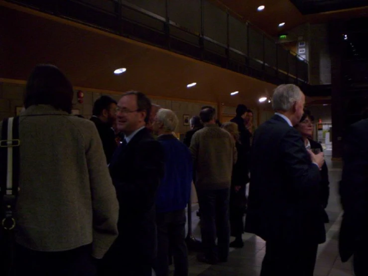 group of business people standing outside the lobby of an office building