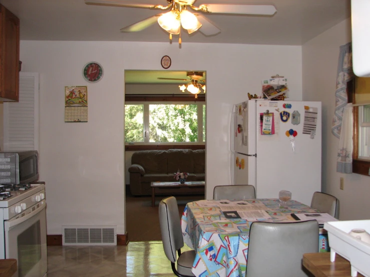 an open kitchen and dining room with a table, chair and couch