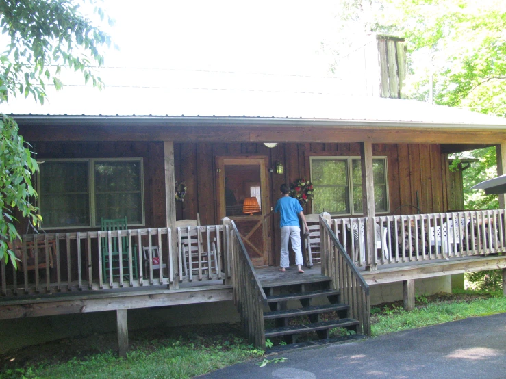 an old cabin with a wooden front porch and porch