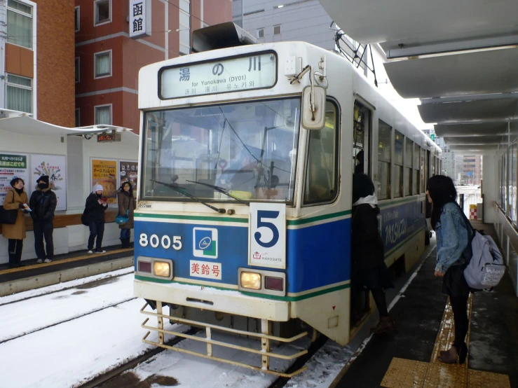 a subway train pulling into the station in winter