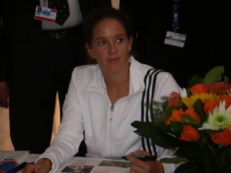 a woman signing soing at a table in a business office