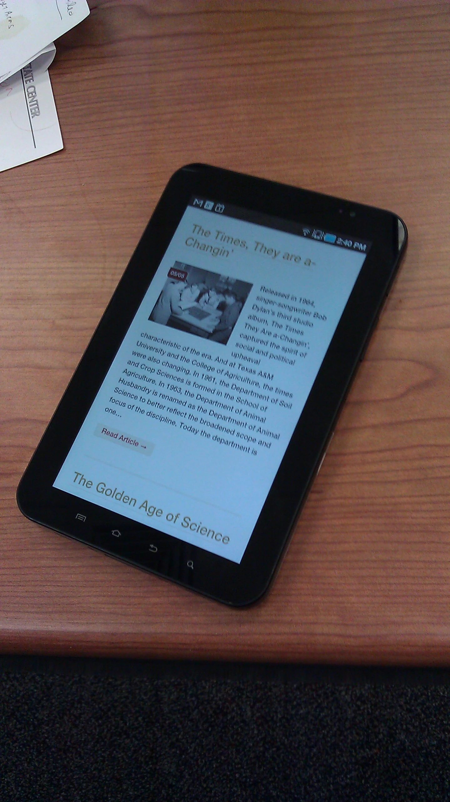 a small tablet sitting on top of a wooden desk