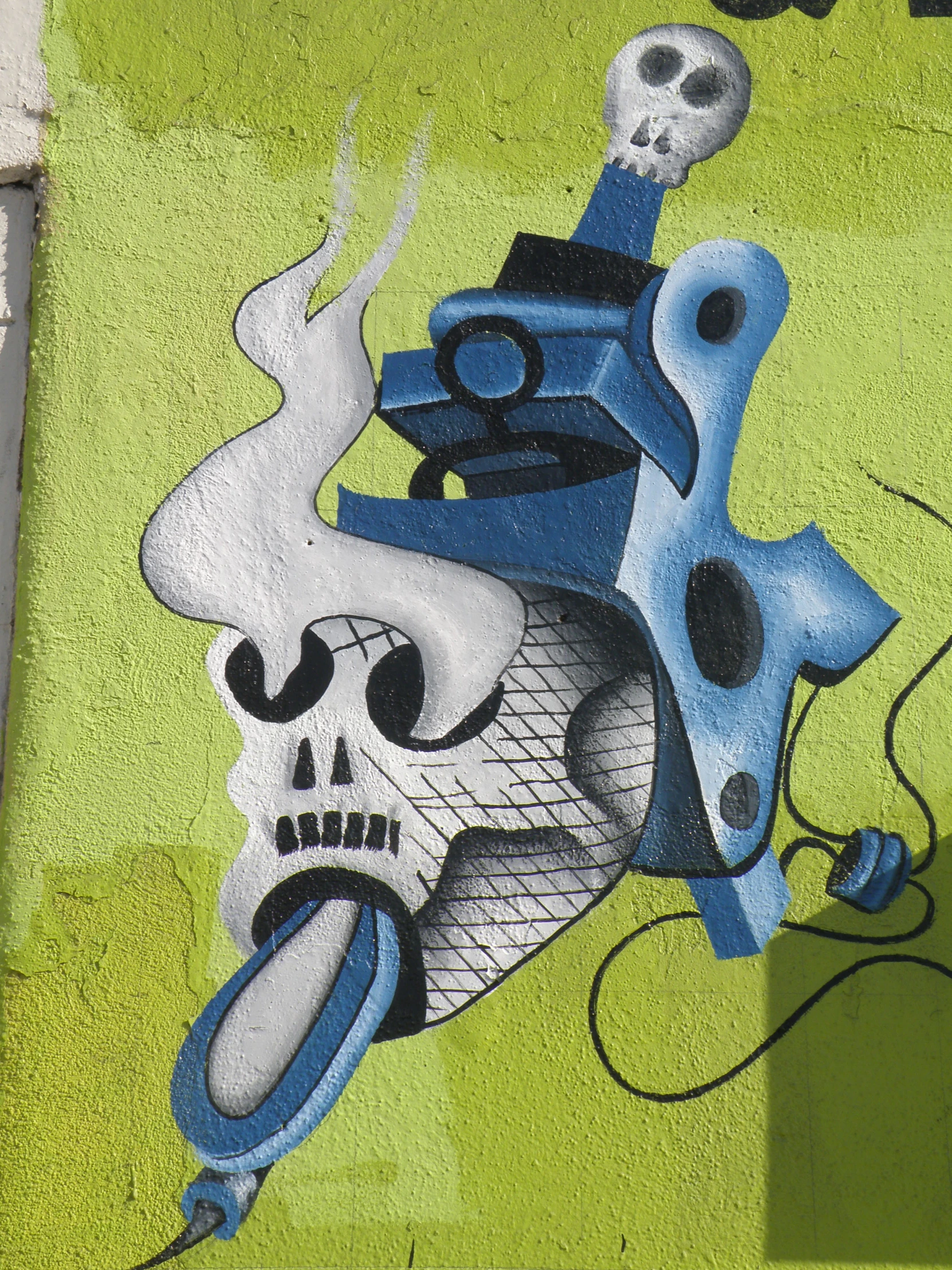 a graffiti painted on the side of a building near a street