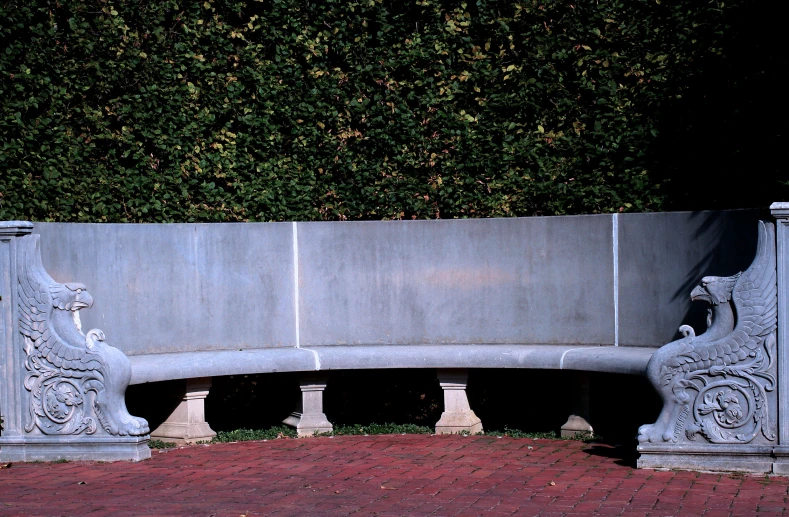 a stone bench that is sitting on bricks