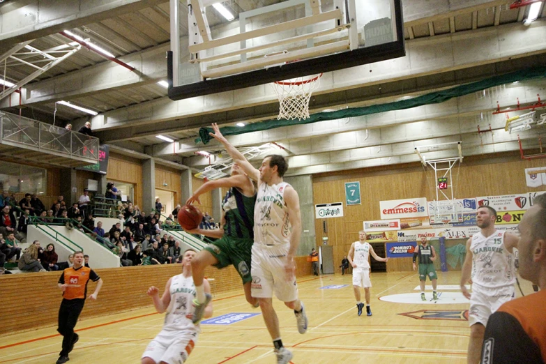 a basketball player goes to dunk the ball