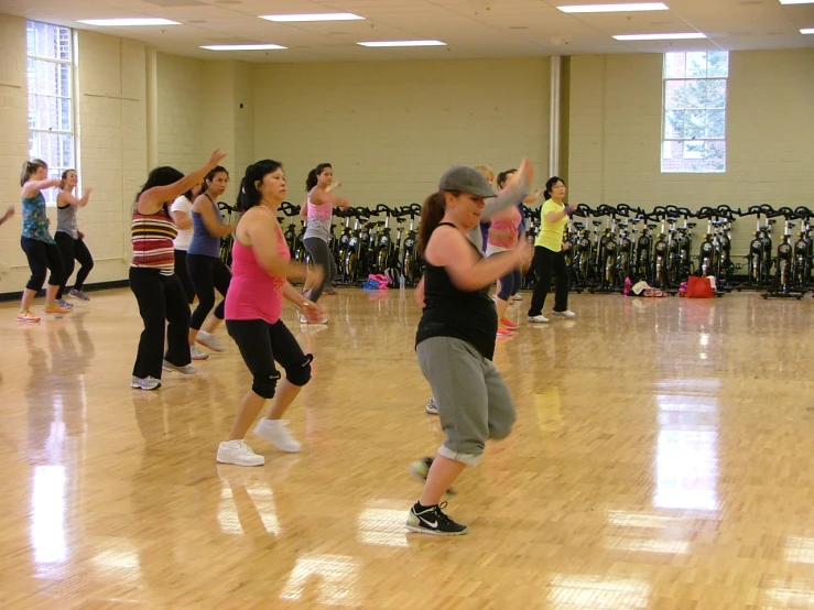 a group of women standing around a gymnasium