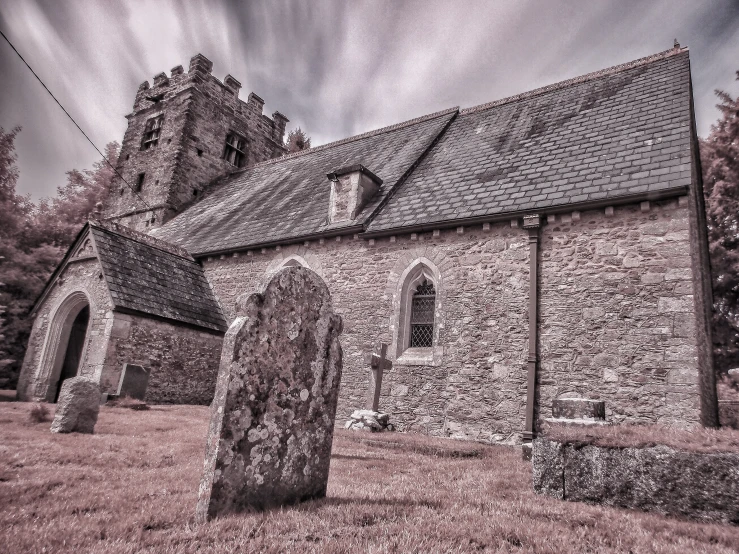 an old church with graves in the yard