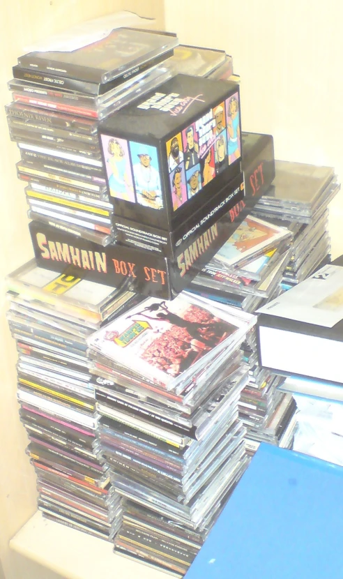 a stack of cds on a desk in a room