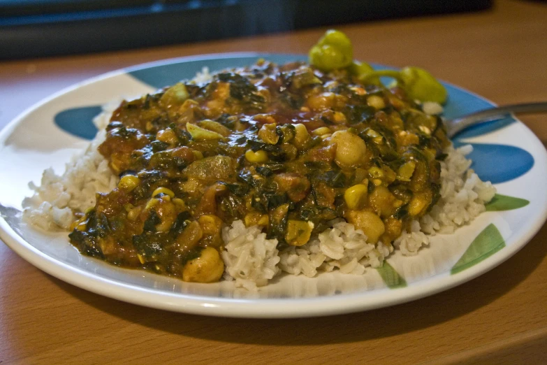 a plate filled with rice and vegetables on a table