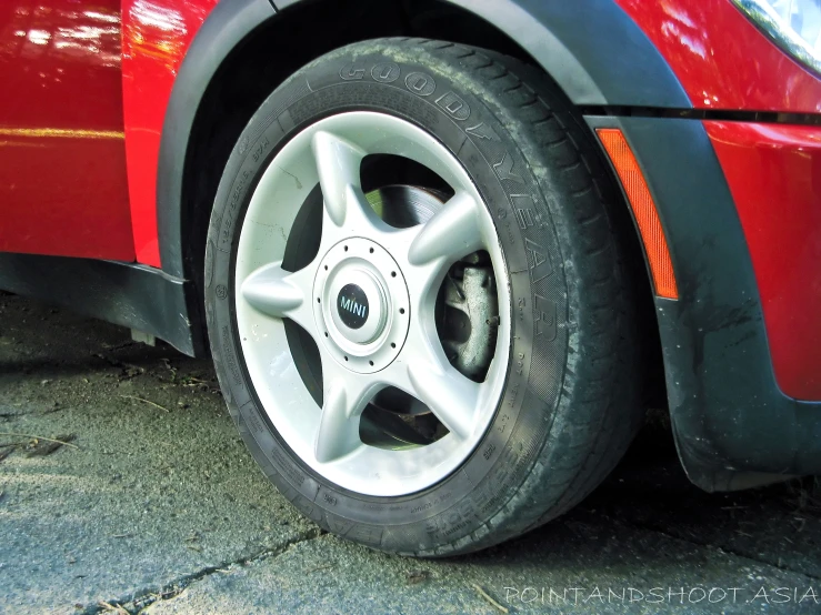 the rim of a red car with an orange top