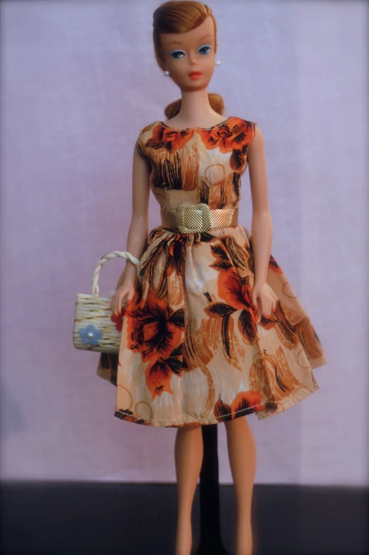 a barbie doll holding a basket with flowers on it