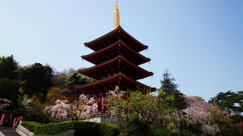a tall tower with red and white decoration on top