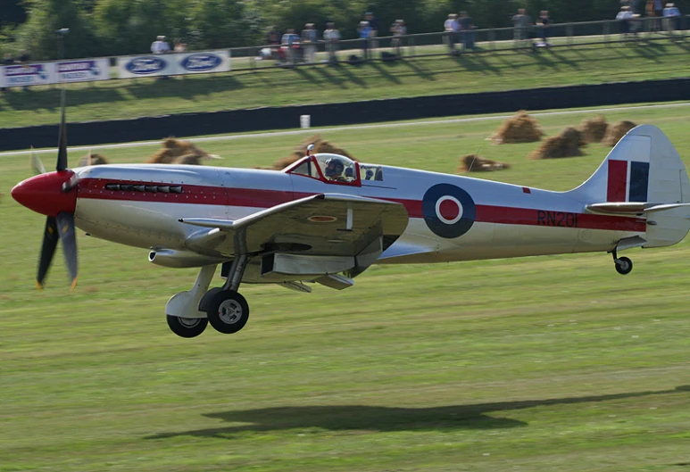 a small plane flying low on the ground