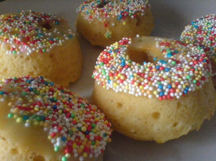 there are many donuts with colorful sprinkles